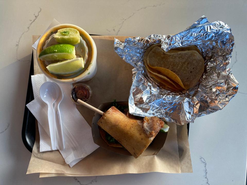 A birria bone marrow taco, birria consumme and extra tortillas from Tuetano Taqueria in San Diego.