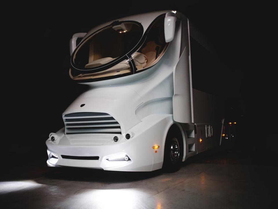 One of Marchi Mobile's large RV's with the headlights on.