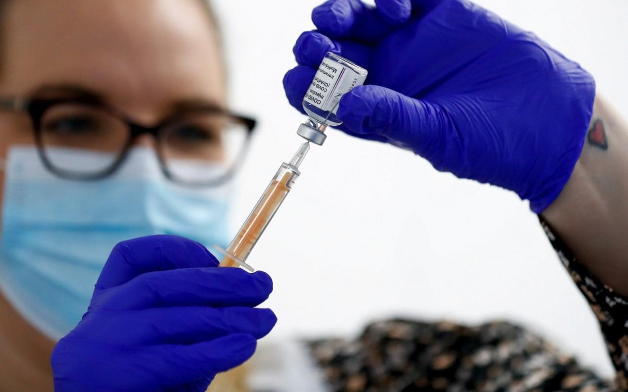 A health worker fills a syringe with a dose of the Oxford vaccine - Jason Cairnduff/Reuters