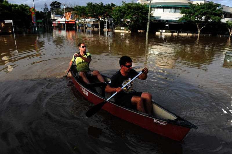 Residents and onlookers take to the flood waters, in all manner of water craft, in the inundated suburb of Rosalie in Brisbane in 2011.