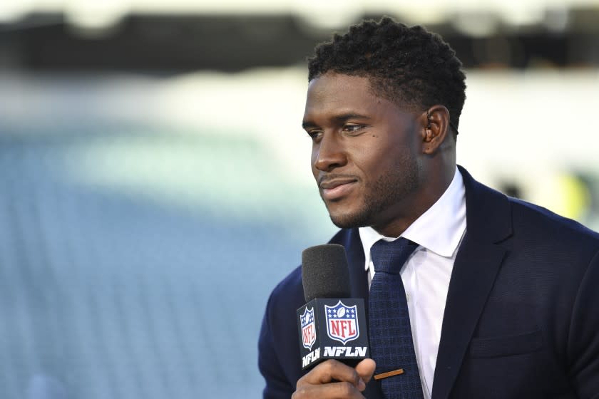 Reggie Bush performs during a program before an NFL football game between the Cincinnati Bengals and the Baltimore Ravens.