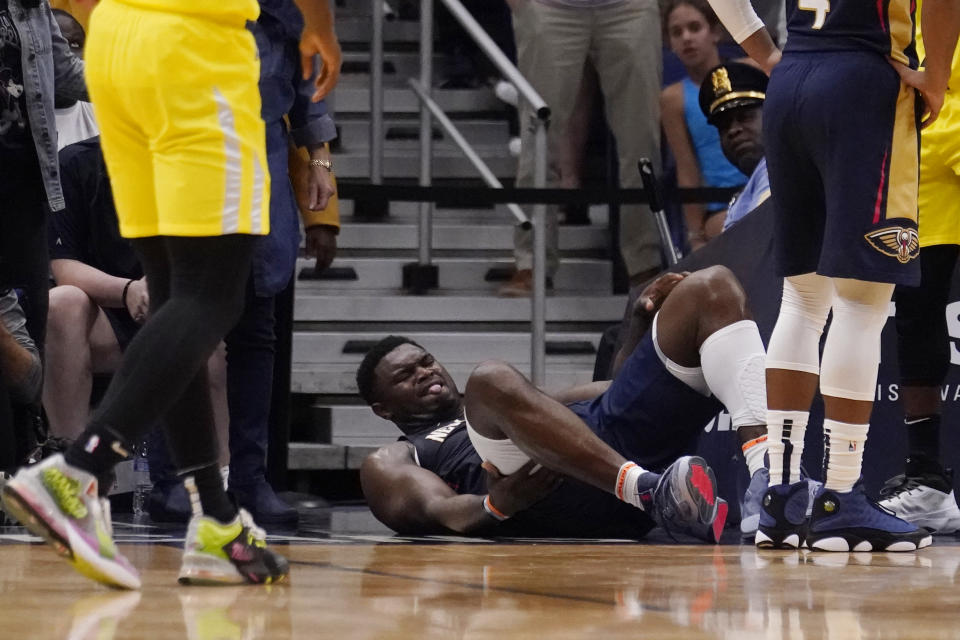 New Orleans Pelicans forward Zion Williamson lies on the ground after going down while driving to the basket in the second half of an NBA basketball game against the Utah Jazz in New Orleans, Sunday, Oct. 23, 2022. Williamson left the game and the Jazz won in overtime 122-121. (AP Photo/Gerald Herbert)