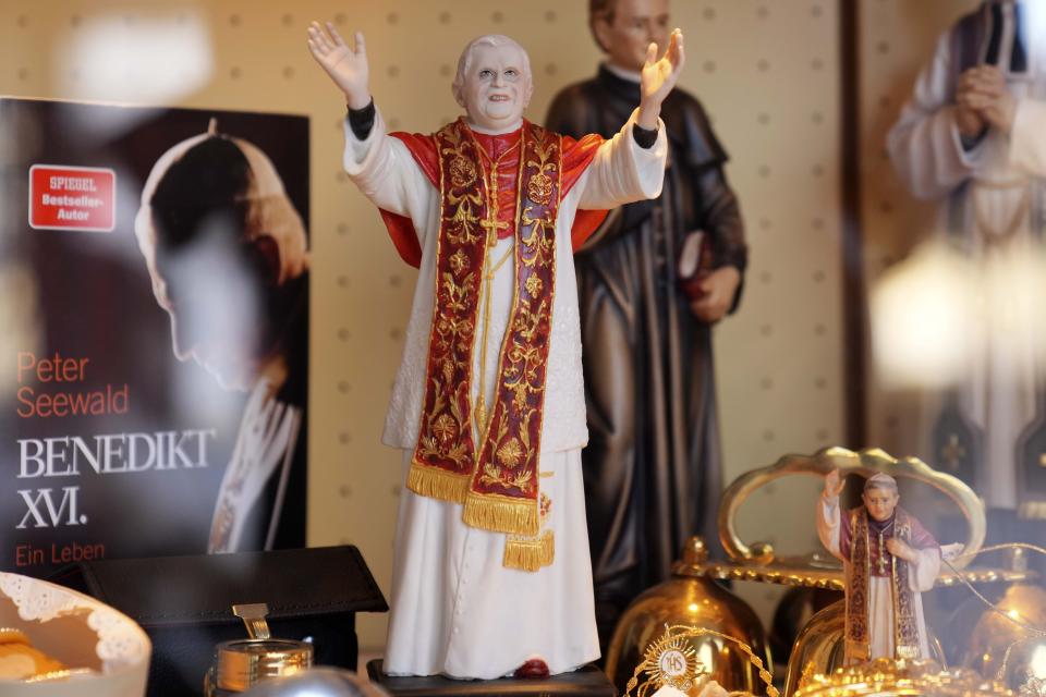 Souvenirs of Pope Benedict XVI are displayed at the main square 'Kapellplatz' in Altoetting, some 90 kilometers (about 55 miles) east of Munich near Marktl, the birthplace of Pope emeritus Benedict XVI, Germany, Thursday, Dec. 29, 2022. The health of Pope Emeritus Benedict XVI has worsened due to his age, and doctors are constantly monitoring the 95-year-old's condition, the Vatican said Wednesday.(AP Photo/Matthias Schrader)