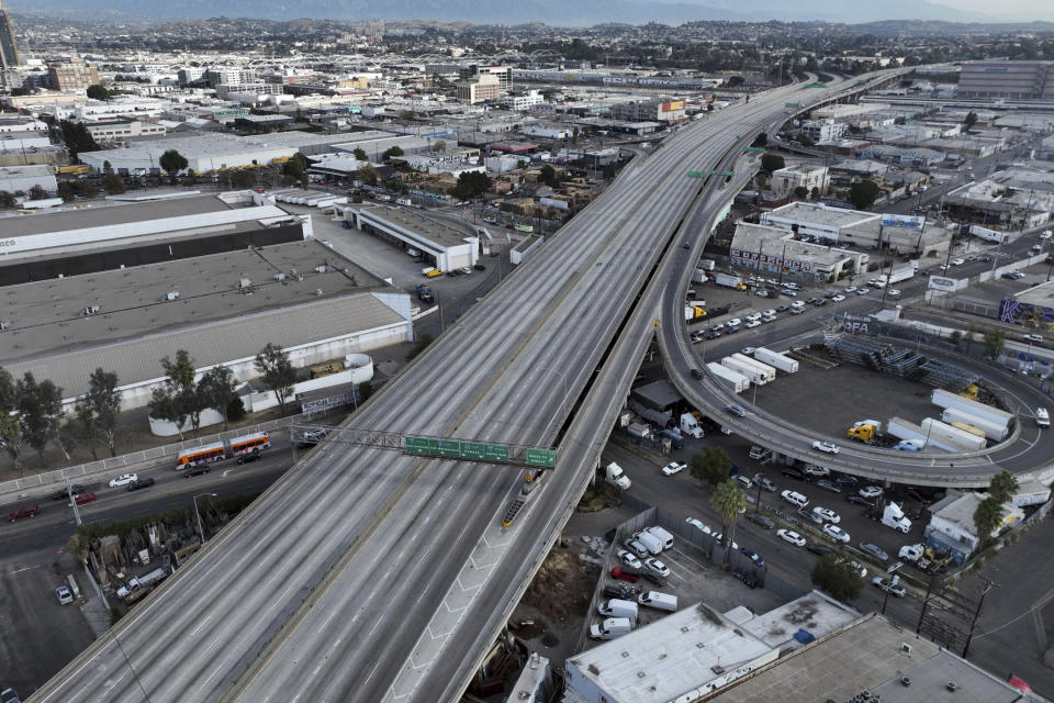 In this aerial view, traffic is backed up under a closed interstate 10 in the aftermath of a fire, Monday, Nov. 13, 2023, in Los Angeles. Los Angeles drivers are being tested in their first commute since a weekend fire that closed a major elevated interstate near downtown. (AP Photo/Jae C. Hong)