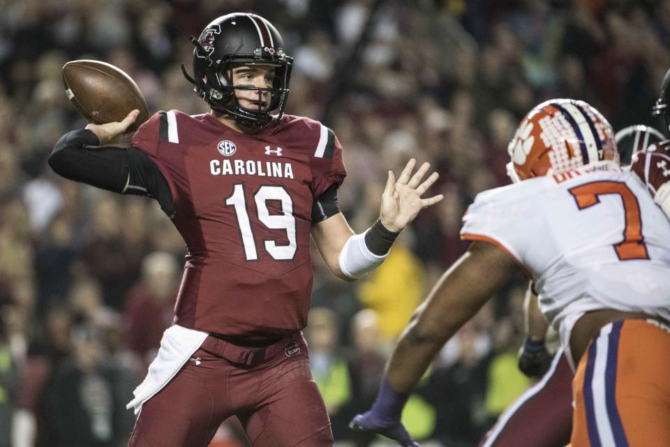 South Carolina quarterback Jake Bentley (19) attempts a pass against Clemson defensive end Austin Bryant (7) during the first half of an NCAA college football game Saturday, Nov. 25, 2017, in Columbia, S.C. (AP Photo/Sean Rayford)