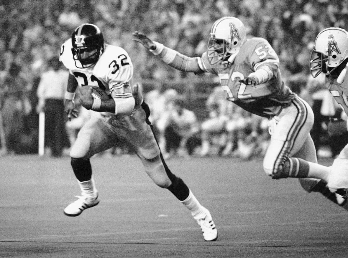 FILE – Pittsburgh Steelers running back Franco Harris (32) picks up 10 yards as he turns the corner as Houston Oilers’ Robert Brazile (52) tries to make a dive to latch on to Harris to make the stop, during an NFL football game in Houston on Dec. 3, 1978. Harris died on Wednesday morning, Dec. 21, 2022, at age 72, just two days before the 50th anniversary of The Immaculate Reception. (AP Photo/Ed Kolenovsky, File)