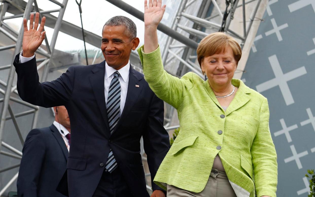Barack Obama shared a stage with Angela Merkel hours before she was due to meet with Donald Trump in Brussels - REUTERS