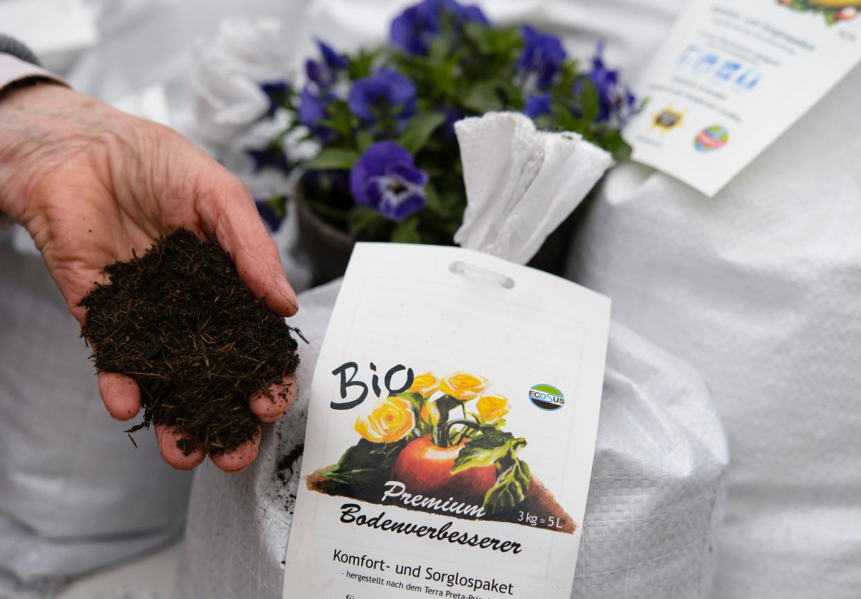 File  A sales assistant shows organic flower soil at the biannual gardeners’ market at the Botanical Gardens on April 5, 2014 in Berlin (Getty Images)