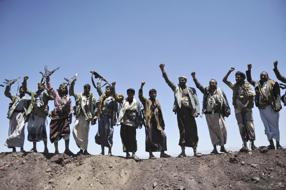 FILE - In this Sept. 22, 2014 file photo, Hawthi Shiite rebels chant slogans at the compound of the army's First Armored Division, after they took it over, in Sanaa, Yemen. Yemen’s war began in September 2014, when the Houthis seized the capital Sanaa. Saudi Arabia, along with the United Arab Emirates and other countries, entered the war alongside Yemen’s internationally recognized government in March 2015. The war has killed some 130,000 people and driven the Arab world’s poorest country to the brink of famine. (AP Photo/Hani Mohammed, File)