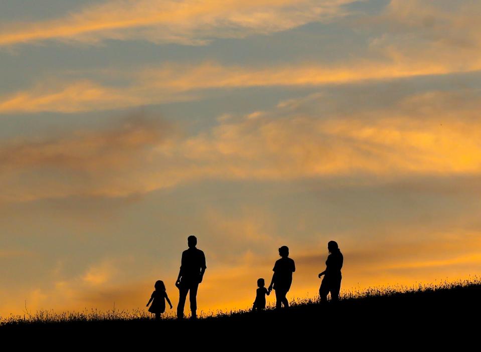 Visitors to the Newark Reservoir at sunset enjoy a break in the heat as temperatures and humidity take a temporary drop, Tuesday, July 11, 2023.