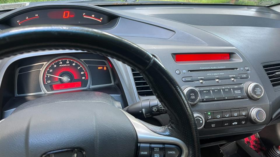 The cockpit is among the eighth-generation Civic's greatest features. Huge center tach, HUD-like speedo, and a minimalistic center stack for comfort controls; it's perfect. Ornamentally, there are enough shapes to keep it interesting while retaining a clean aesthetic. This was a high-water mark for automotive interior design. <em>Andrew P. Collins</em>