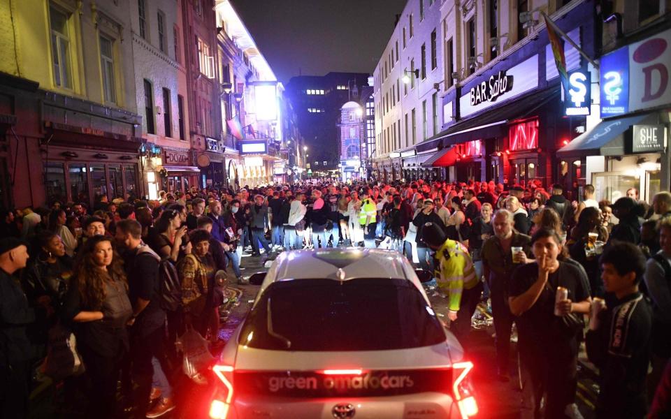 A car tries to drive through a crowded Soho street - Justin Tallis/AFP