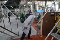 Rabbi Joseph Schwartz inspects some machinery as he supervises the koshering for Hanan Products' kosher-for-passover production run, Thursday, Jan. 7, 2021, in Hicksville, N.Y. (AP Photo/Seth Wenig)