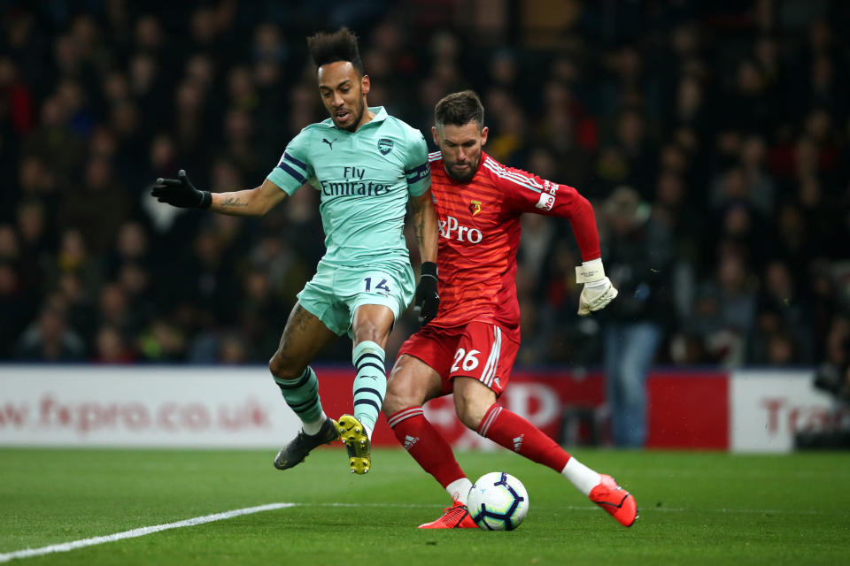 Pierre-Emerick Aubameyang of Arsenal closes down Ben Foster of Watford and scores the winning goal during the Premier League match between Watford and Arsenal at Vicarage Road.