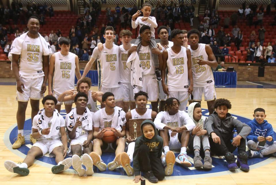 Akron St. Vincent-St. Mary pose for a team photo after their victory over Louisville in the DII regional final at the Canton Memorial Civic Center on Saturday, March 12, 2022.