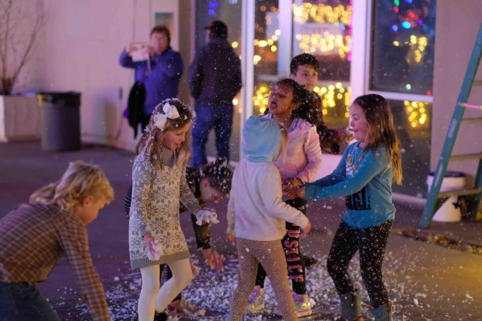 Children play in the snow at the  Amarillo Botanical Gardens  Thursday during its Christmas in the Garden event.