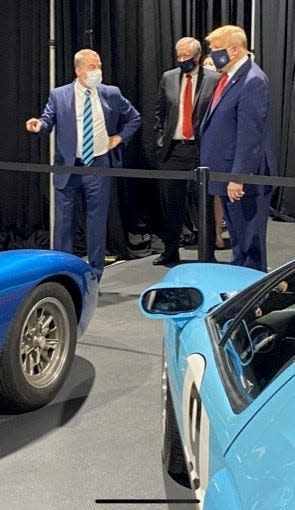 Bill Ford Jr., executive chairman of Ford Motor Co., points to a collection of Ford GT vehicles while talking with President Donald Trump during his visit to the Rawsonville plant in Ypsilanti on May 21, 2020. Mark Meadows, White House chief of staff, is standing in the middle.