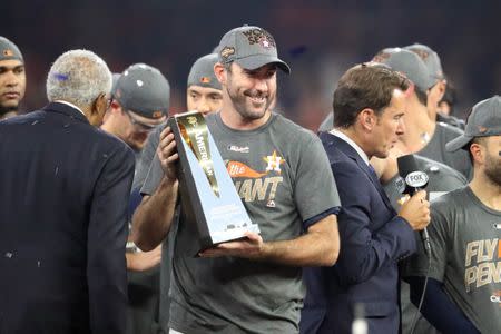 Oct 21, 2017; Houston, TX, USA; Houston Astros starting pitcher Justin Verlander (35) holds the MVP trophy after game seven of the 2017 ALCS playoff baseball series between the Houston Astros and the New York Yankees at Minute Maid Park. Thomas B. Shea-USA TODAY Sports