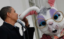 <p>President Barack Obama jokingly acts like he is speaking in the ear of the Easter Bunny after his microphone failed to work as he attended the White House Easter Egg Roll on the South Lawn of the White House, Monday, April 13, 2009, in Washington. (AP Photo/J. Scott Applewhite) </p>