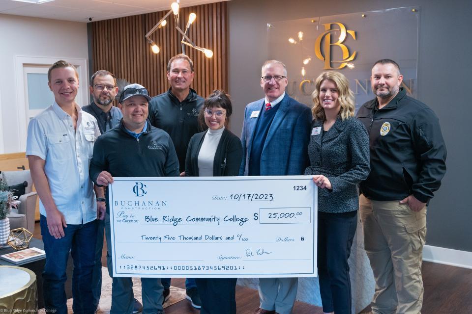 Buchanan Construction presents a check to Blue Ridge Community College in honor of Ryan Hendrix. Pictured from left to right are front row: Thomas Hendrix, residential construction manager, Buchanan Construction; Jeff Hendrix, carpentry manager, Buchanan Construction; Vanessa Crook, office manager, Buchanan Construction; Dr. Scott Queen, vice president for economic and workforce development, Blue Ridge Community College; Trina Stokes, executive director, Blue Ridge Community College Educational Foundation; Chris White, chief of police, Blue Ridge Community College Police Dept. Back Row: Jason Norton, vice president of residential construction, Buchanan Construction and Rick Buchanan, owner and president, Buchanan Construction.