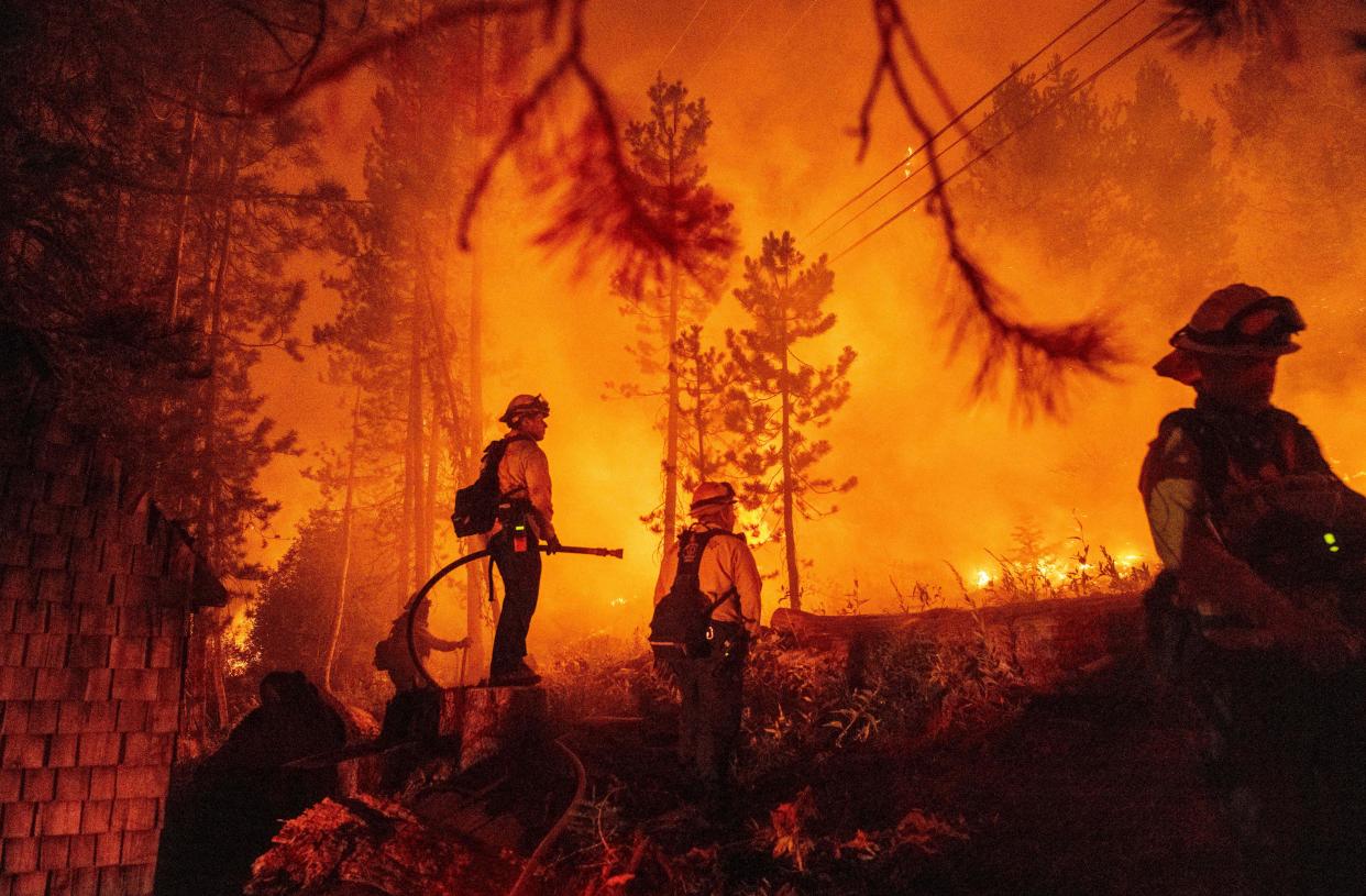 Firefighters work to protect a home 