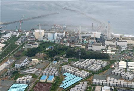 An aerial view shows Tokyo Electric Power Co. (TEPCO)'s tsunami-crippled Fukushima Daiichi nuclear power plant and its contaminated water storage tanks (bottom) in Fukushima in this file photo taken by Kyodo on August 20, 2013. REUTERS/Kyodo/Files