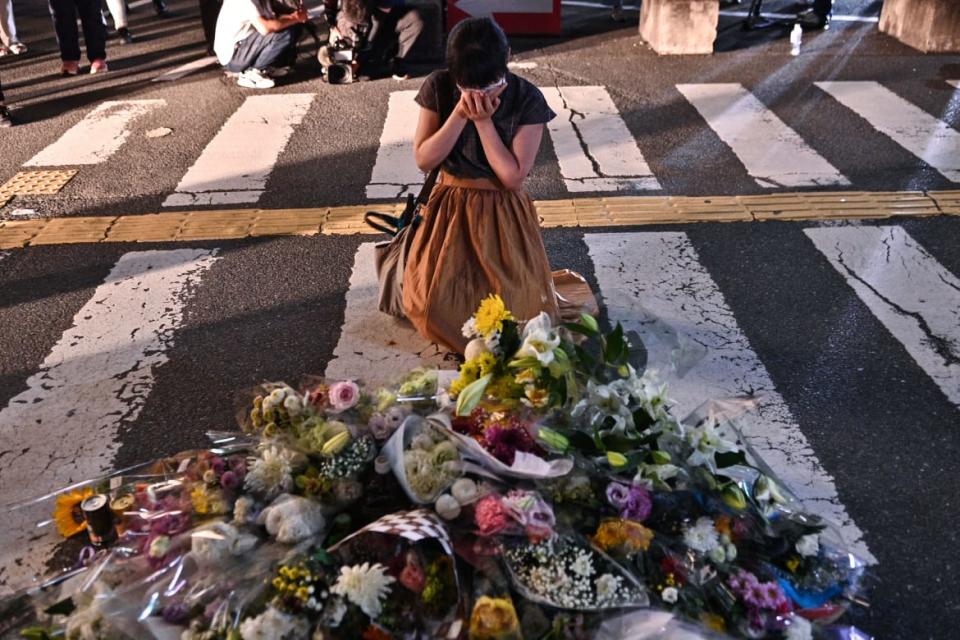 <div class="inline-image__caption"><p>A woman reacts in front of a makeshift memorial where people place flowers at the scene outside Yamato-Saidaiji Station in Nara where former Japanese prime minister Shinzo Abe was shot earlier in the day.</p></div> <div class="inline-image__credit">Philip Fong/AFP via Getty</div>