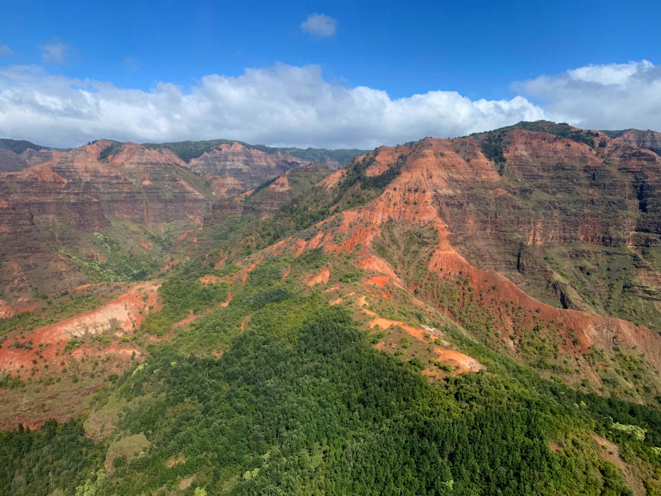 This Dec. 17, 2019, aerial photo shows the Na Pali Coast on the island of Kauai in Hawaii. The Coast Guard is searching for a tour helicopter that disappeared on the Na Pali Coast with seven people aboard on Thursday, Dec. 26, 2019. Authorities say the helicopter's owner called for help about 45 minutes after the chopper was due back from the tour. (AP Photo/Maryclaire Dale)