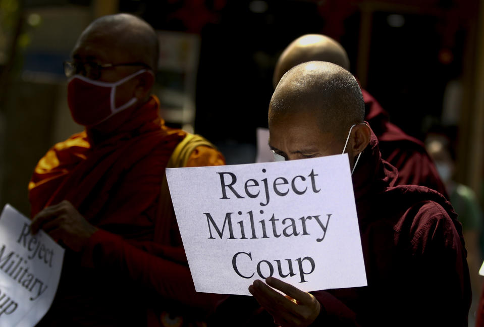 Buddhist monks display placrds during a protest march against the military coup in Yangon, Myanmar Tuesday, Feb. 16, 2021. Peaceful demonstrations against Myanmar's military takeover resumed Tuesday, following violence against protesters a day earlier by security forces and after internet access was blocked for a second straight night. (AP Photo)