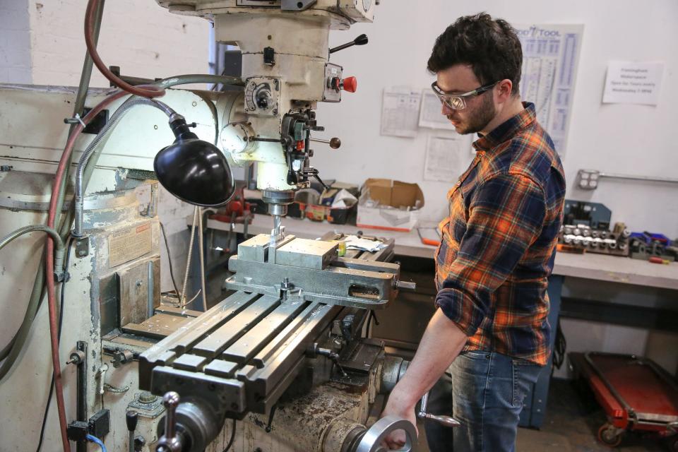 Member Evan Warniers uses the milling machine at the Framingham Makerspace, Aug. 10, 2022.