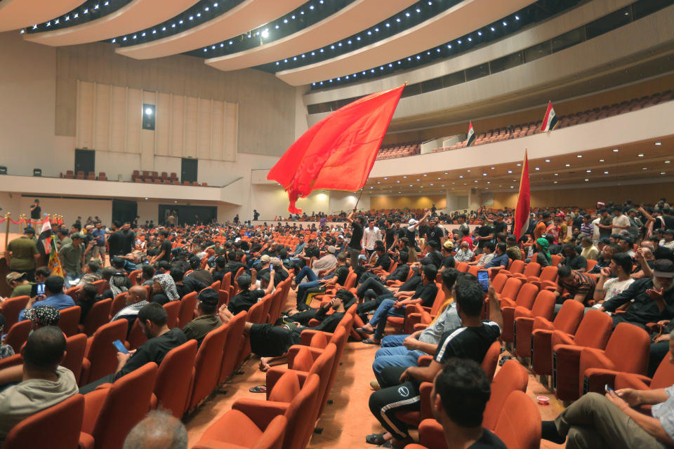 Followers of Shiite cleric Muqtada al-Sadr fill the parliament building during a sit-in protest, in Baghdad, Iraq, Wednesday, Aug. 3, 2022. The Influential Shiite cleric has told his followers to continue their sit-in inside Iraq's government zone, and called for the dissolution of the parliament and early elections. (AP Photo/Anmar Khalil)