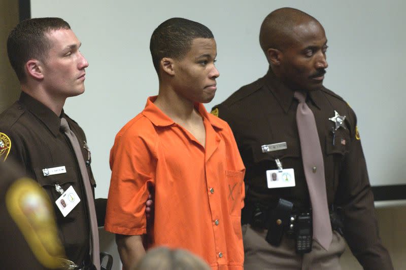 18-year old sniper suspect Malvo is surrounded by deputies as he is brought into court to be identified by a witness during the trial of sniper suspect John Allen Muhammad at the Virginia Beach Circuit Court in Virginia Beach