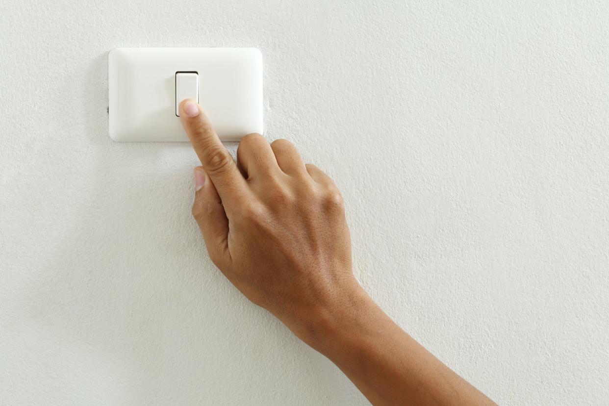 closeup of hand touch electric switch