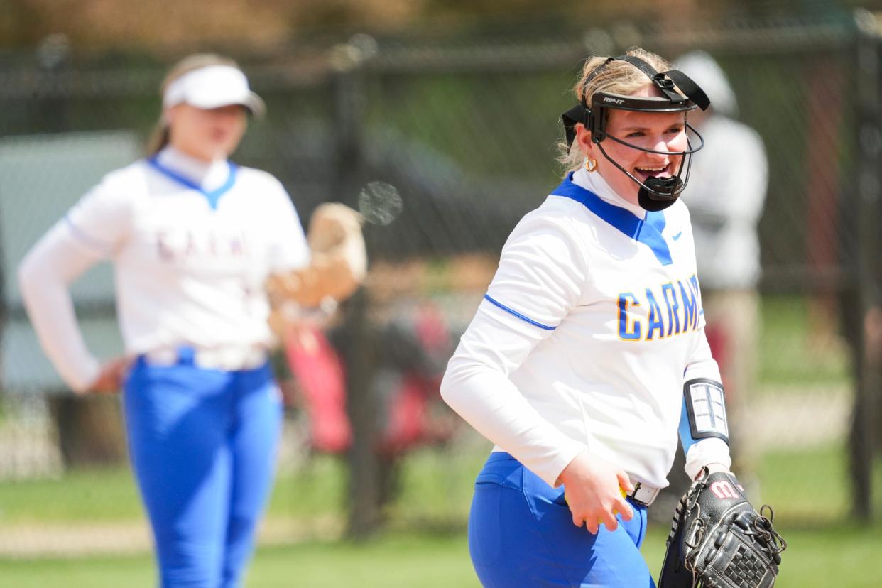 Carmel Greyhounds Chelsea Bennett (13) smiles at her coach while pitching against the Roncalli Royals during the Carmel Softball Invitational on Saturday, April 20, 2024, at the Cherry Tree Softball Complex in Carmel, Indiana.