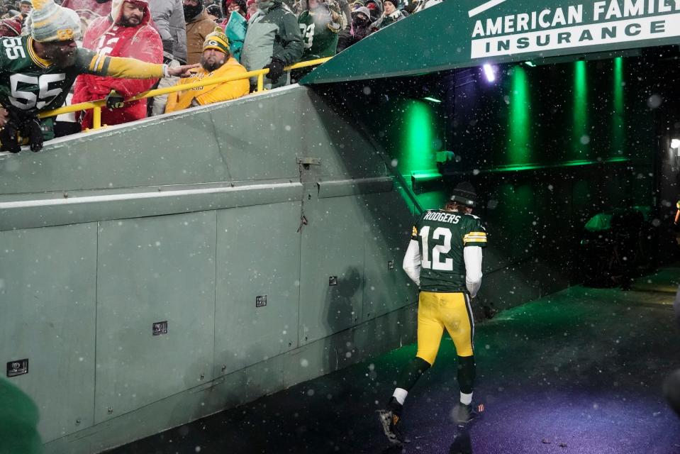 Aaron Rogers leaves Lambeau Field after a playoff loss in January 2022.