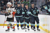 Seattle Kraken right wing Jordan Eberle, right, and center Jaden Schwartz, second from right, head to the bench after Schwartz's goal, as Anaheim Ducks right wing Jakob Silfverberg (33) skates away during the second period of an NHL hockey game Thursday, March 28, 2024, in Seattle. (AP Photo/Jason Redmond)