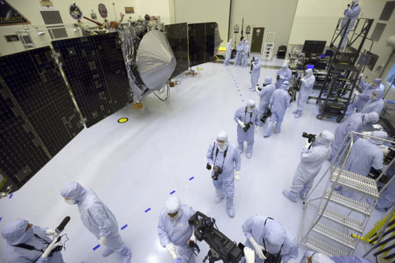 Inside the Payload Hazardous Servicing Facility at NASA's Kennedy Space Center in Florida, reporters and photographers look over the Mars Atmosphere and Volatile Evolution, or MAVEN, spacecraft on Sept. 27, 2013. The Mars orbiter is due to laun