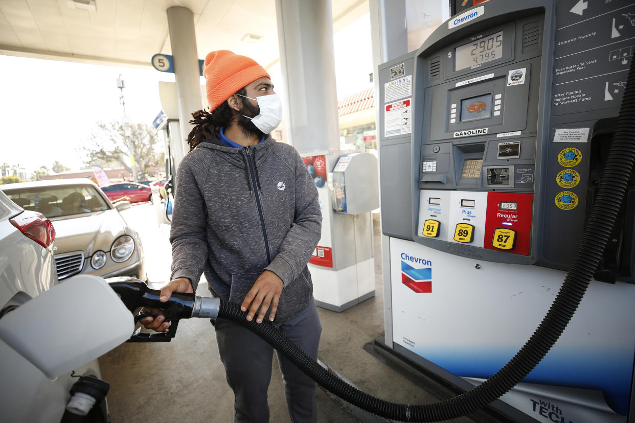 LOS ANGELES, CA - NOVEMBER 15:                                                                      Damian Maculam, 29, watches the total increase as drivers select from various fuels all priced over $6 dollars at a Chevron Gas Station located at North Alameda and West Cesar Chavez Ave near Union Station in downtown Los Angeles as California gas prices hit an average price of $4.676 Sunday, setting the highest recorded average price for regular gasoline, according to AAA. Americas largest state by population has the highest gas prices in the country. The national average dropped slightly to $3.413 Sunday.        Downtown on Monday, Nov. 15, 2021 in Los Angeles, CA. (Al Seib / Los Angeles Times via Getty Images).