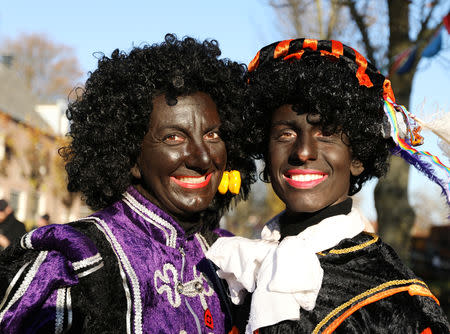 "Zwarte Piet" (Black Pete), who are a Saint Nicholas' assistants are seen during a traditional parade in Zaanstad, Netherlands, November 17, 2018. Picture taken November 17, 2018. REUTERS/Eva Plevier