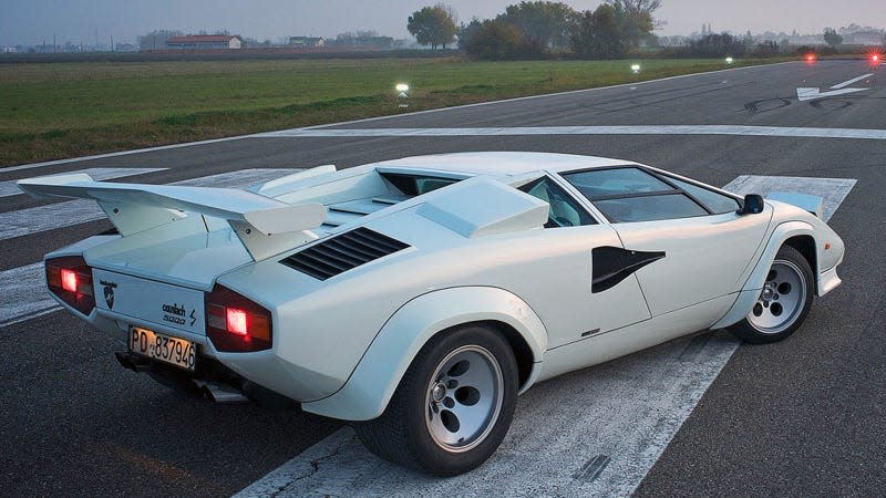 A photo of the rear end of a white Lamborghini Countach. 