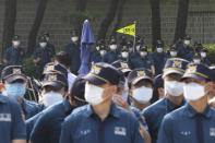 Police officers wearing face masks to help protect against the spread of the new coronavirus stand guard near the presidential Blue House in Seoul, South Korea, Thursday, July 9, 2020. (AP Photo/Ahn Young-joon)