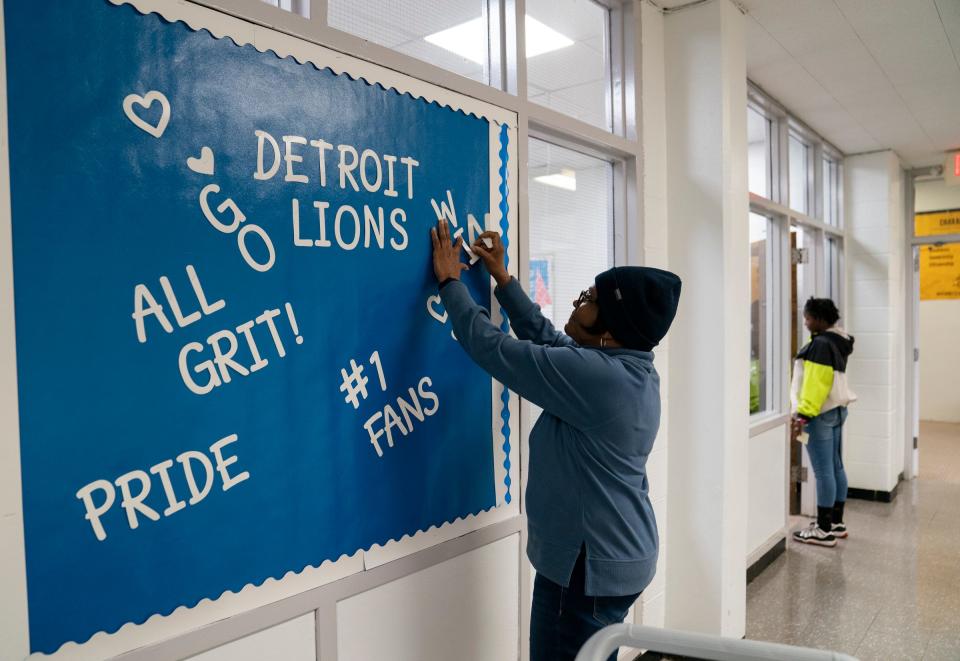 Wilma King, 73, of Detroit, puts up a spirited Lions sign at the Detroit Lions Academy on Friday, Jan. 26, 2024. King likes to volunteer at the school, where her daughter, Alean King, is the school's head principal.