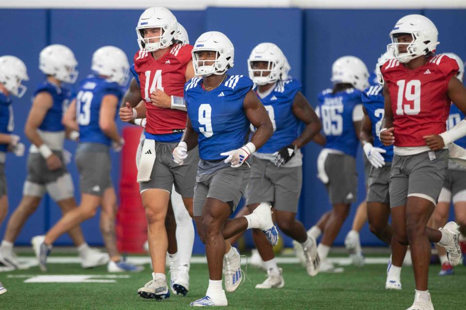 Kansas football players move during a practice July 31 in Lawrence.