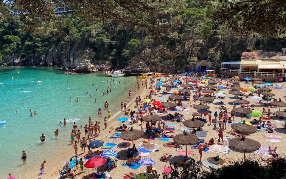 Sunbathers enjoy the sunny weather on Cala Aiguablava Beach, amid the coronavirus outbreak in Begur, near Girona, Costa Brava - REUTERS/Nacho Doce