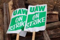 "UAW on strike" picket signs lay on a pile of wood outside the General Motors Detroit-Hamtramck Assembly in Hamtramck