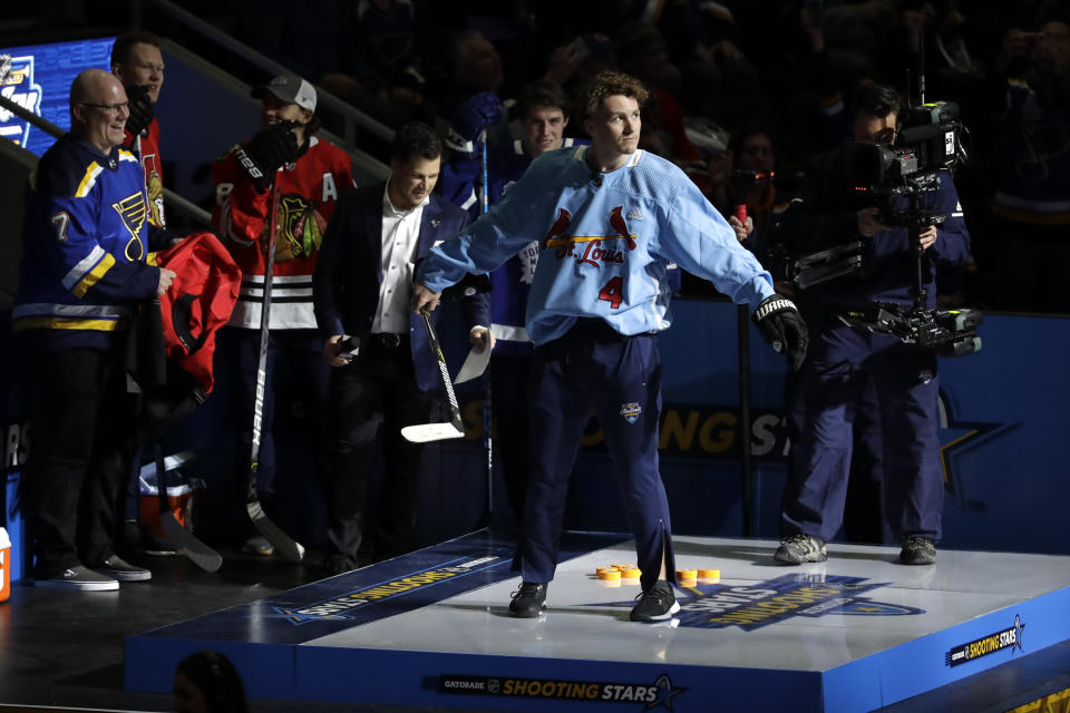 Calgary Flames' Matthew Tkachuk wears a St. Louis Cardinals jersey during the Skills Competition shooting stars event, part of the NHL All-Star weekend, Friday, Jan. 24, 2020, in St. Louis. (AP Photo/Jeff Roberson)