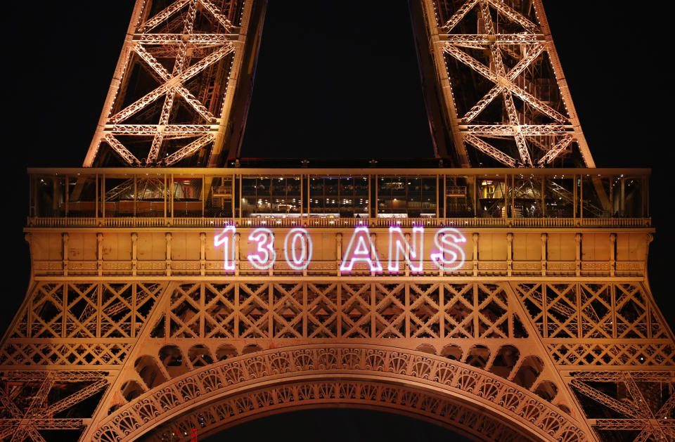 A light show illuminates the Eiffel Tower for its 130 year anniversary, in Paris, Wednesday, May 15, 2019. Paris is wishing the Eiffel Tower a happy birthday with an elaborate laser show retracing the monument's 130-year history. (AP Photo/Christophe Ena)