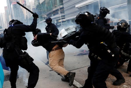 Anti-government protesters clash with riot police as they demonstrate in Hong Kong