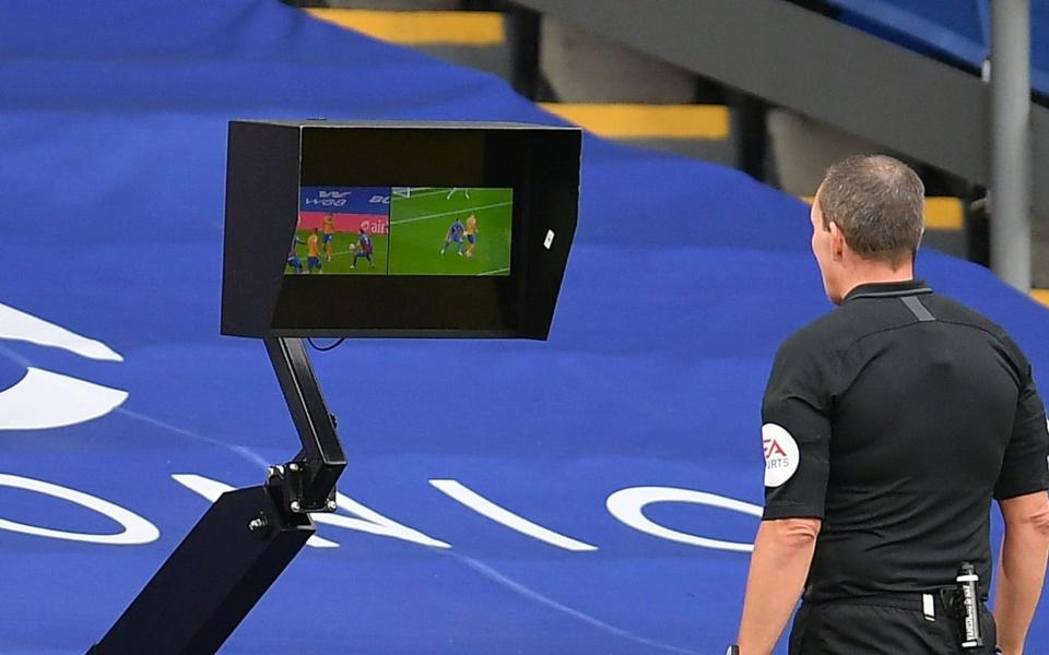 Referee Kevin Friend reviews a handball penalty decision during the English Premier League match between Crystal Palace and Everton i - Shutterstock