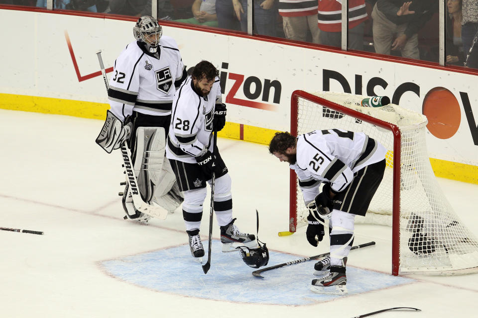 NEWARK, NJ - JUNE 09: Jonathan Quick #32, Jarret Stoll #28 and Dustin Penner #25 of the Los Angeles Kings recover from a scuffle in front of the net against the New Jersey Devils during Game Five of the 2012 NHL Stanley Cup Final at the Prudential Center on June 9, 2012 in Newark, New Jersey. (Photo by Jim McIsaac/Getty Images)